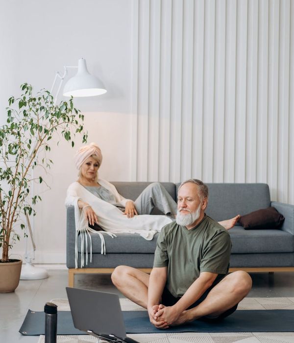 Woman in activewear smiling feeling energetic in a minimalist room.
